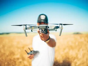 Man with aerial drone in farm field